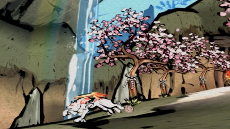 オオカミの神アマテラスが急いで小道を駆け下り、背後に桜の木が見え、ピンクの花びらが満開。 