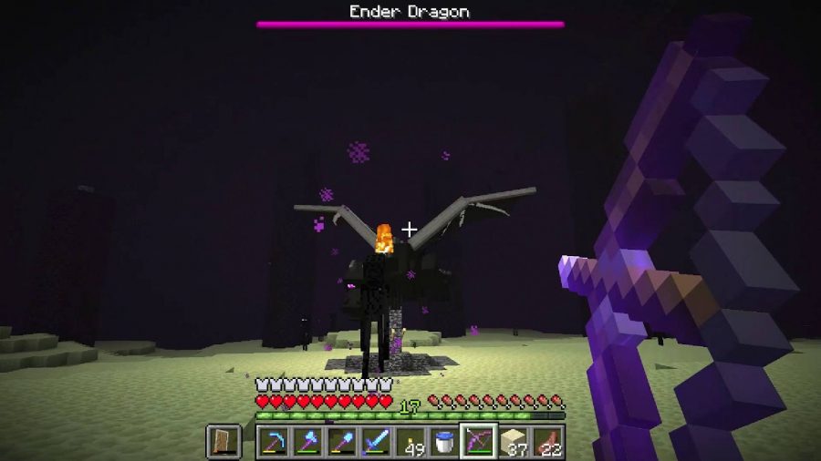 Minecraftエンダードラゴン：Minecraftの画像は、エンダードラゴンとして知られる巨大なドラゴンの敵を攻撃しているプレーヤーを示しています