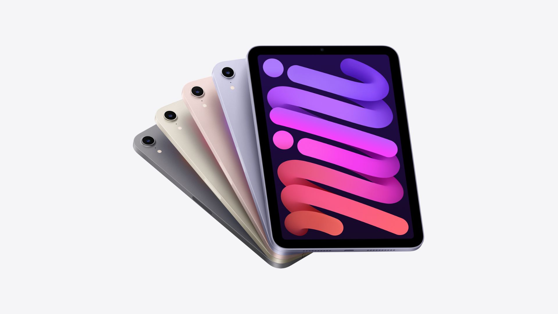 最高の iPad の 1 つである iPad mini は、複数回表示され、さまざまな色 (左から右へ、黒、緑、ピンク、紫、紫) のトランプのように広がっていました。 一番左の山は上向きで、画面に紫と赤の色のストロークがあり、残りはカードのように互いに隠れており、左上隅に小さなカメラリングが表示されています.
